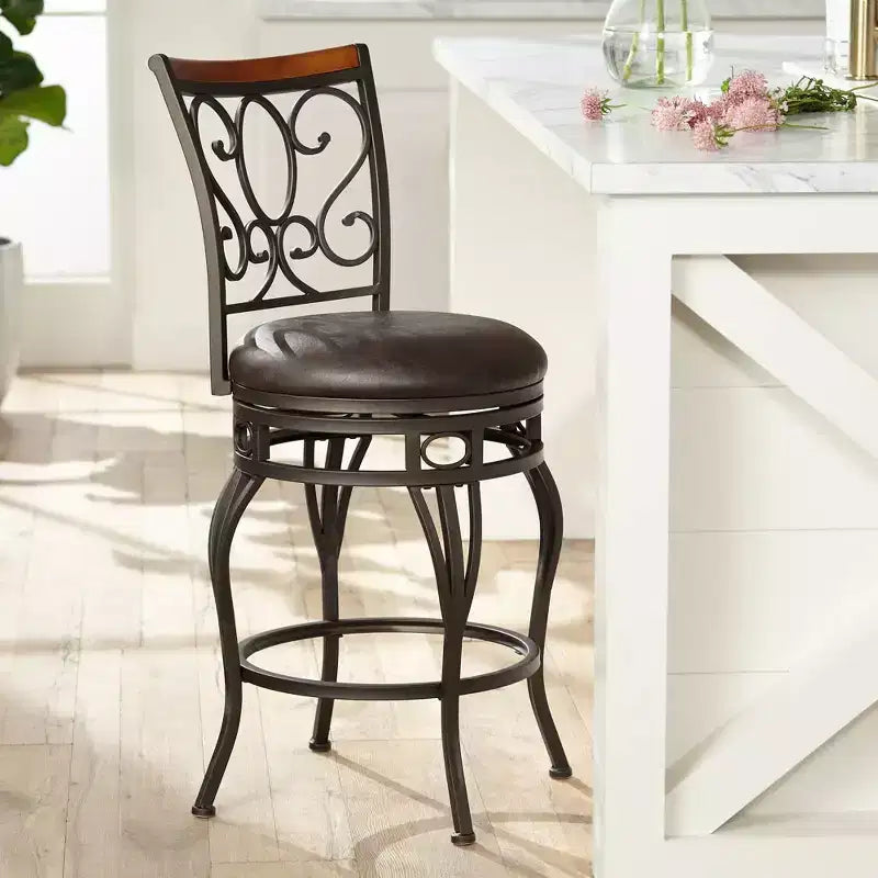 Tabouret de comptoir pivotant en bronze avec siège en similicuir et dossier en volutes